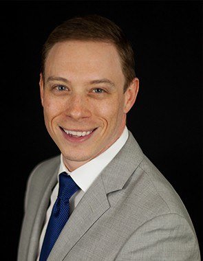 Wall Township New Jersey dentist Jason Aptaker D M D wearing gray suit