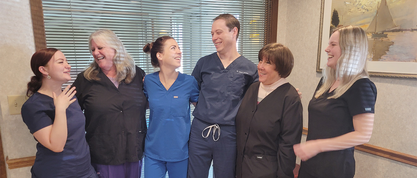 Wall Township dentist and team members laughing together