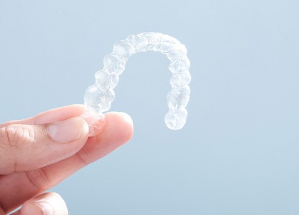 Patient holding clear aligner