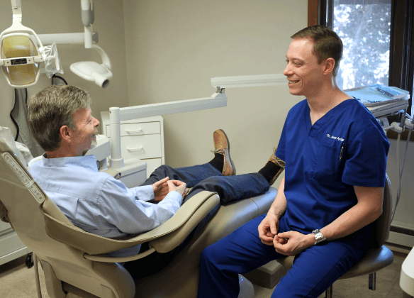 Dr. Aptaker talking to dental patient