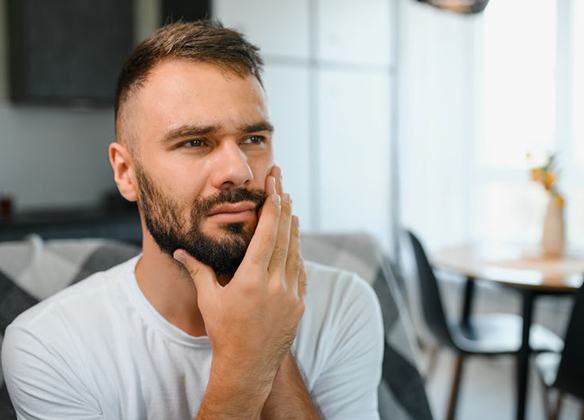 Concerned man touching the side of his face
