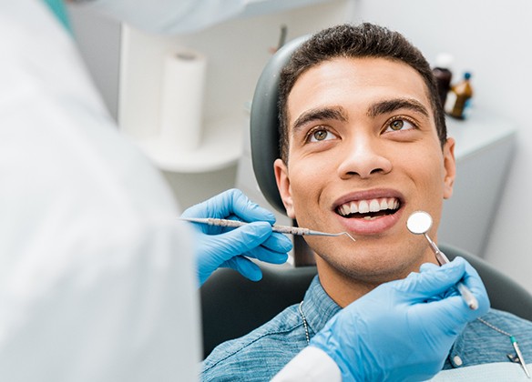 A young male having his teeth checked and cleaning during a regular visit