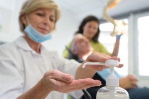 dentist in Manasquan sanitizing their hands